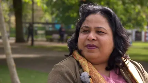 Nagina Kaleem sat on bench in a park