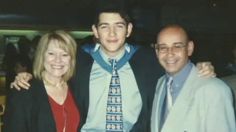 Family photo James with his mother and father at graduation