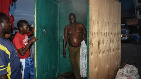 Getty Images A man leaves a steam inhalation booth in Dar es Salaam, Tanzania, on 22 May, 2020