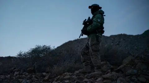Getty Images A member of Constitutional Patriots New Mexico Border Ops Team militia is pictured on patrol at the US-Mexico border