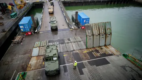 PA Media Military vehicles driving on to MV Anvil Point at the Sea Mounting Centre in Marchwood