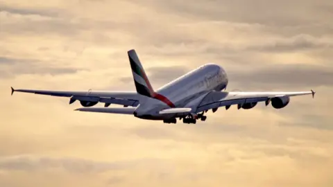 An Emirates Airbus flight in the sky after taking off from Manchester Aiport