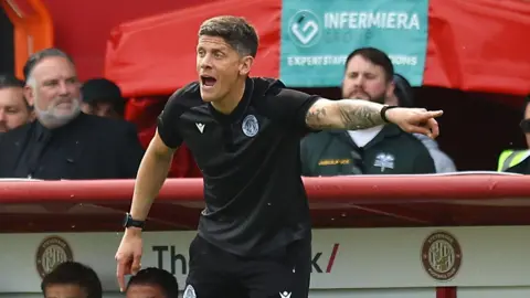 Alex Revell points with his left index finger as he urges his Stevenage team on in the play-off first leg against Stockport