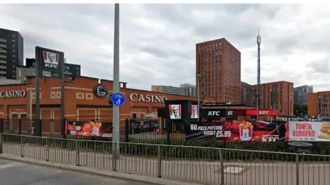 A Grosvenor Casino and KFC restaurant in a section of an urban retail park. Some tower blocks can be seen nearby.
