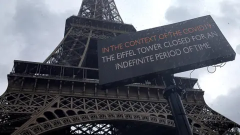 EPA A sign notifies the closure of the Eiffel Tower. 14 March 2020