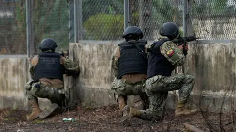 Reuters Soldiers guard a gate after several inmates were killed in fights between gangs, in Guayaquil, Ecuador November 2, 2022.