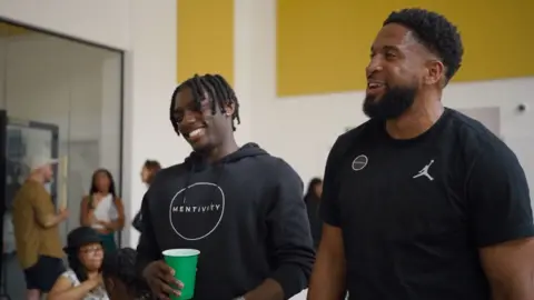 Adeyemi Michael Sayce Holmes-Lewis and a Mentivity mentor in the new youth club