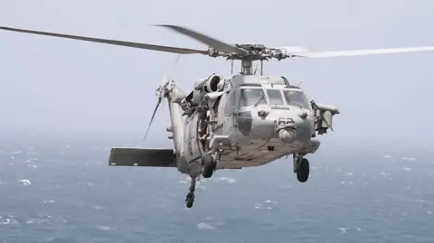 A photo of a US Navy MH-60 helicopter used by US Central Command in its post to inform about missile strikes on a cargo ship