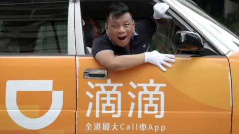 Getty Images Ng Shu-kei, City Manager of Didi Chuxing Hong Kong, poses in a taxi at Jordan.