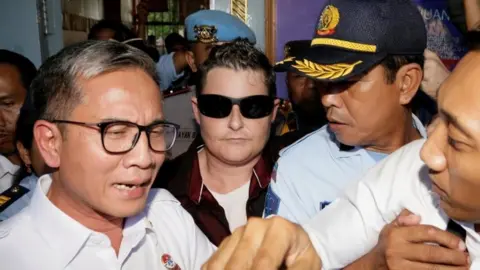 Reuters Australian Renae Lawrence (C) surrounded by police leave prison in Bali