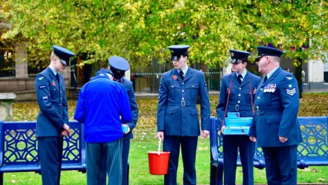 BBC Selling poppies near St Philip's Cathedral