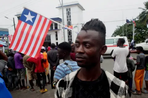 EPA A man wears a flag in Monrovia during Liberian Flag Day, a holiday that was first observed in 1847 when the founding fathers approved the flag's design along with establishing the new republic.
