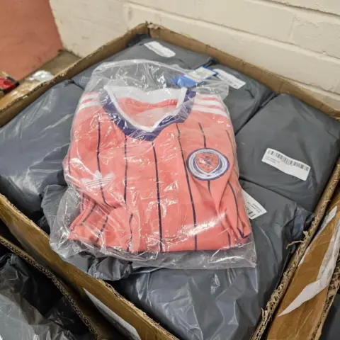 City of Edinburgh Council A pink Scotland football top in plastic wrapping