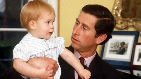 Getty Images Prince Harry pictured aged one with his father, the Prince of Wales