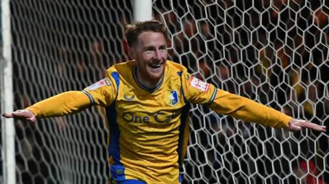 Stephen Quinn celebrates a goal for Mansfield