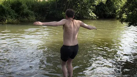 Getty Images Man jumping into river