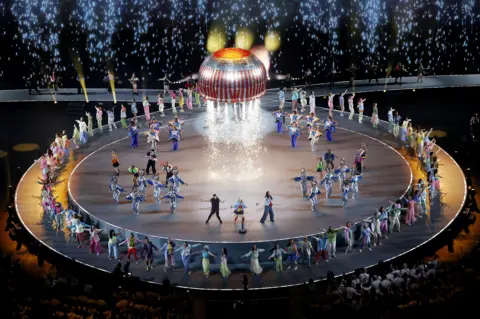 Getty Images Tunnock's Teacake rocket taking off on stage at the end of the opening ceremony