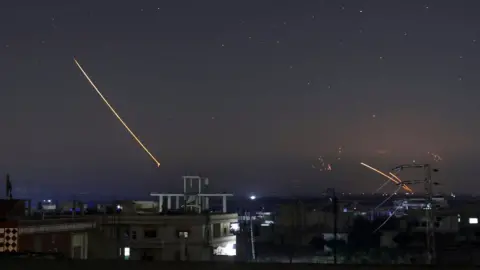 Reuters Missile fire seen over the southern Syrian city of Deraa on 10 May 2018