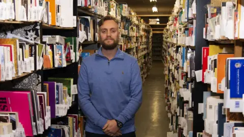 WeBuyBooks Ben Wadsworth, marketing manager at WeBuyBooks in their warehouse in Waterfoot, Rossendale.