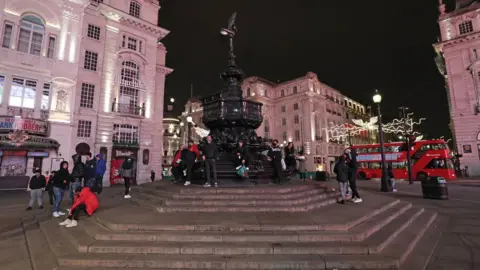PA Media The statue of Eros in Piccadilly Circus in London, as London"s New Year"s Eve fireworks display has been cancelled due to the coronavirus pandemic.