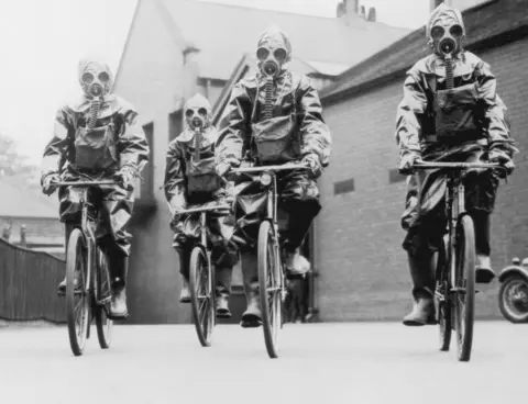 Getty Images Cyclists of the London police unit wearing gas masks