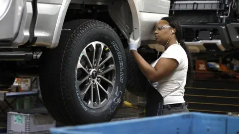 Getty Images A worker at a Ford factory in Michigan