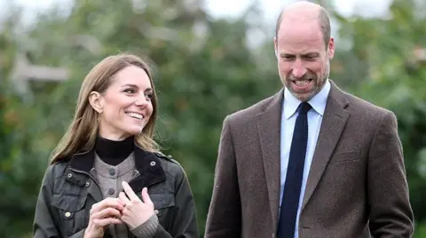 Getty Images Catherine, Princess of Wales and Prince William, Prince of Wales walk in the orchards on October 14, 2025