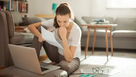 Getty Images Woman looking at laptop