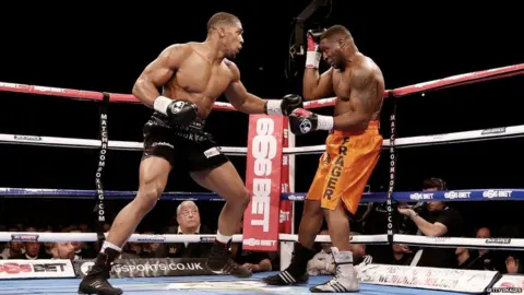 Getty Images Joshua prepares to punch Sprott