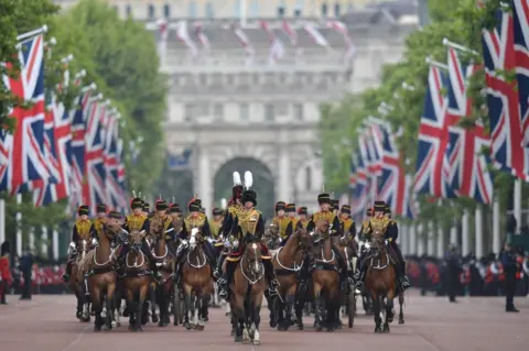 Daniel Leal-Olivas/AFP/Getty Images Members of The Kings Troop Royal Artillery lead the parade down the Mall back to Buckingham Palace after of the Queens Birthday Parade, Trooping the Colour