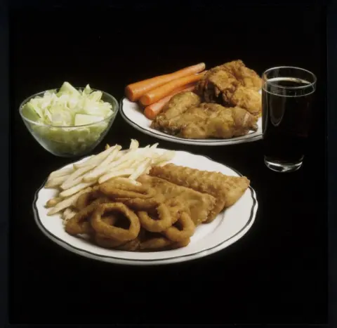 Jackie Black A meal featuring lettuce, onion rings, french fried, carrots and chicken nuggets