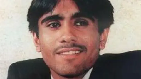 Family handout Man with moustache smiling to camera