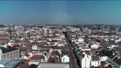 A drone shot of a number of buildings and homes in Jersey. 