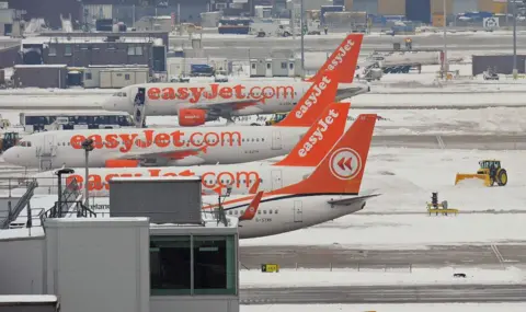 Getty Images A snowplough clears snow near Easyjet aircraft at Gatwick airport in West Sussex on December 19, 2010.