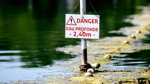 A river in France with a danger sign 
