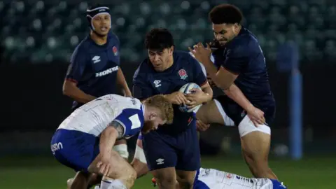 Kepu Tuipulotu runs into a tackle during an England U20 match