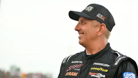Getty Images Greg Biffle, driver of the #69, looks on from the front stretch before a heat race at a Camping World Superstar Racing Experience at I-55 Raceway on July 9, 2022 in Pevely, Missouri.