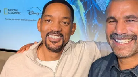 Will Smith and Richard Parks are hugging shoulder to shoulder