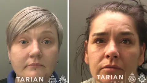 Tarian A composite image of two women - they are custody stills. One on the left has short grey/blonde hair and a nose ring, lip piercing and earrings. The one on the right has messy purple-dyed hair. They both look at the camera - they are both head shots.