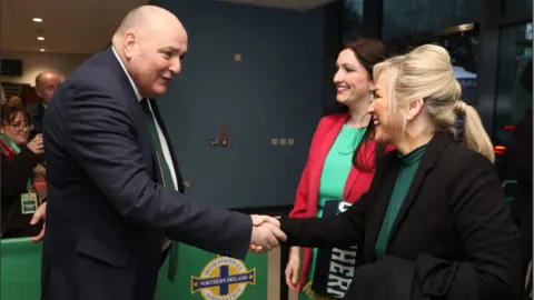 PA Media Irish Football Association president Conrad Kirkwood greeted Michelle O'Neill and Emma Little-Pengelly on their arrival