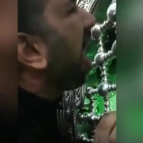 @alinejadMasih man licking holy shrine in Qom Iran