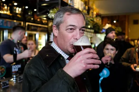 Getty Images Nigel Farage drinks a pint as he visits Seaham, 2019