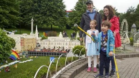 PA Media Joanna and Duncan Brett with their disabled son Sebby, seven and daughter Lottie, six, during a visit to Legoland