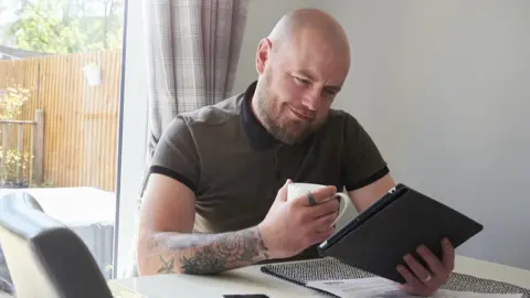 Getty Images Man reading credit score