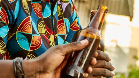 Getty Images People holding beer bottles