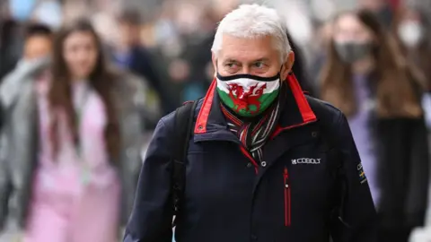 Getty Images Man wearing Welsh flag face mask