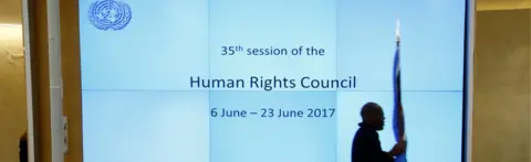 Reuters A staff member carries a flag before the United Nations Human Rights session in Geneva, Switzerland June 6, 2017