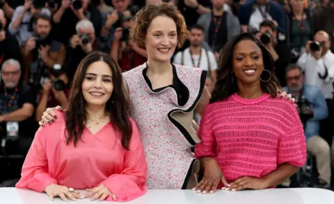 Reuters Un Certain Regard Jury members Maimouna Doucoure, Asmae El Moudir, Vicky Krieps pose during a photocall at the 77th Cannes Film Festival in Cannes, France, May 15, 2024.