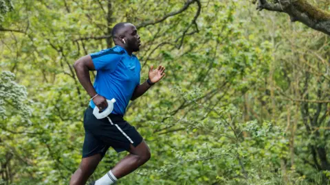 Getty Images Man runs in a park 