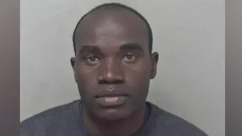 A man in a grey jumper. 